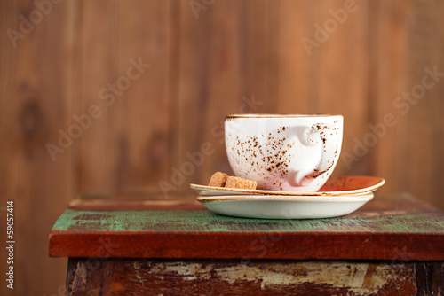 Cup of coffee with sugar on a beautiful rustic background