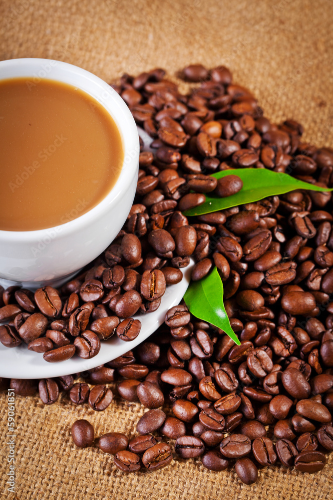 Fototapeta premium coffee cup and arabica beans on cloth sack