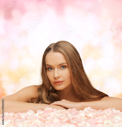woman with long hair and rose petals