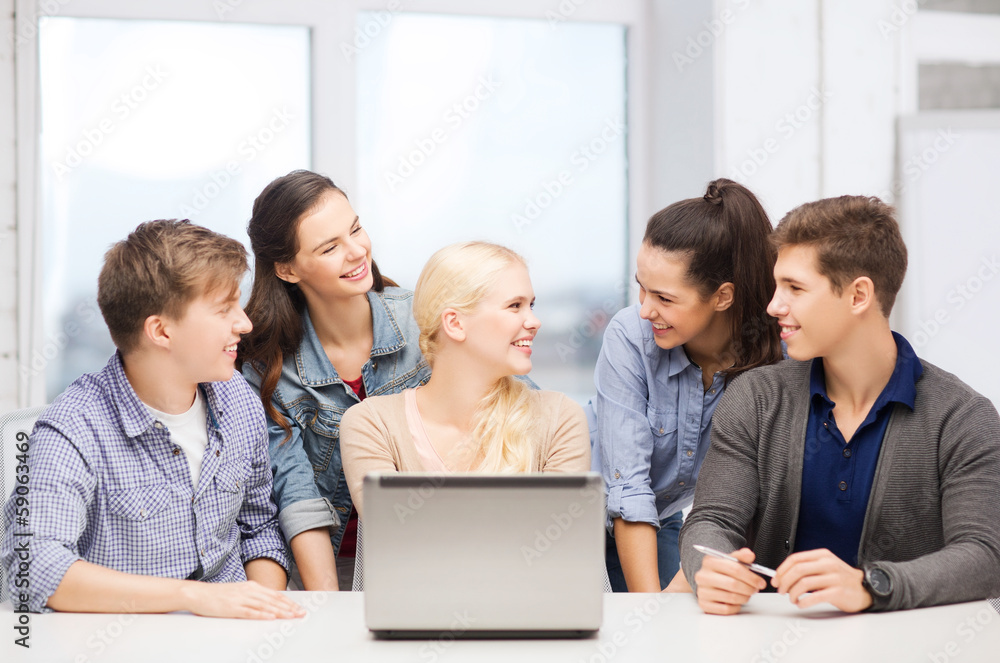 smiling students with laptop at school smiling students with laptop at school