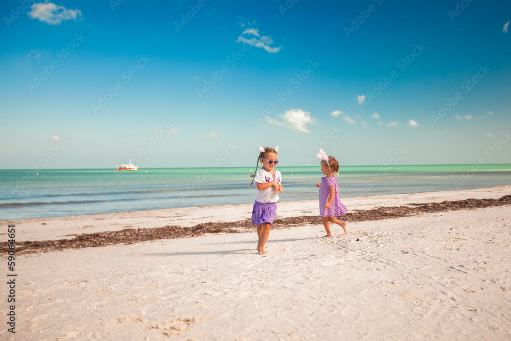 Two little cute girls in easter ears have fun on the exotic