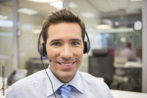 Businessman in the office on the phone with headset photo