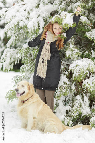 Young woman with dog at winter