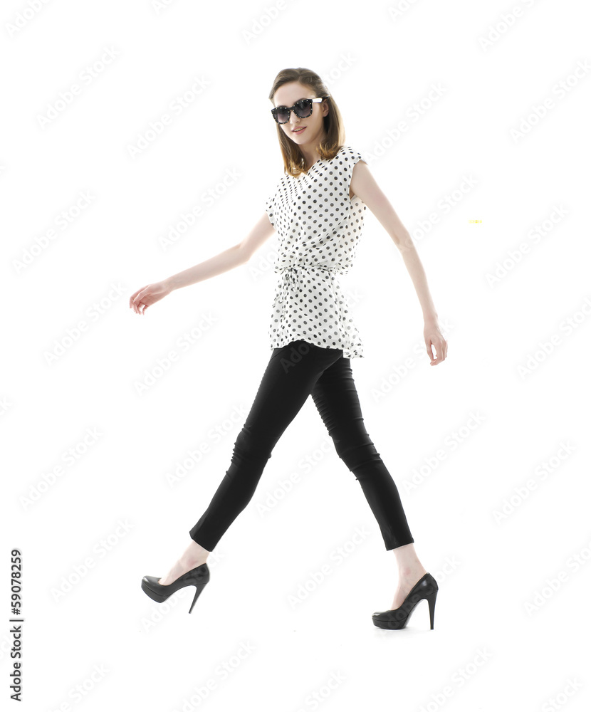 Full body beautiful stylish girl in sunglasses walking in studio Full body beautiful stylish girl in sunglasses walking in studio