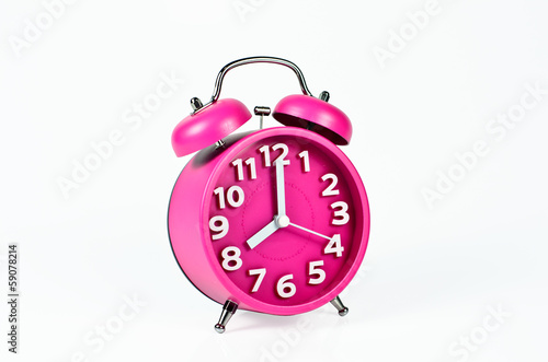 Retro pink alarm clock isolated on white
