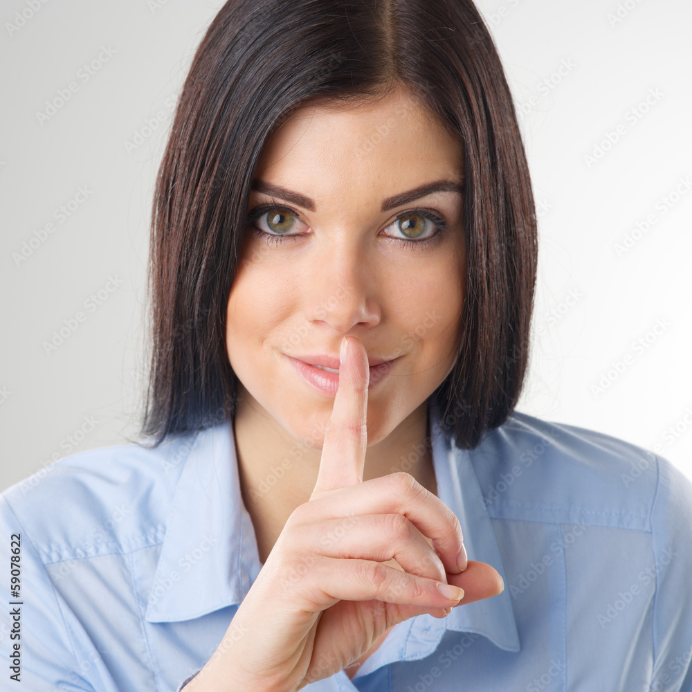 Woman making a shushing gesture Woman making a shushing gesture