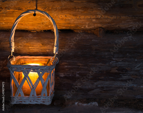 lantern with glowing candle on old wooden wall © Maya Kruchancova