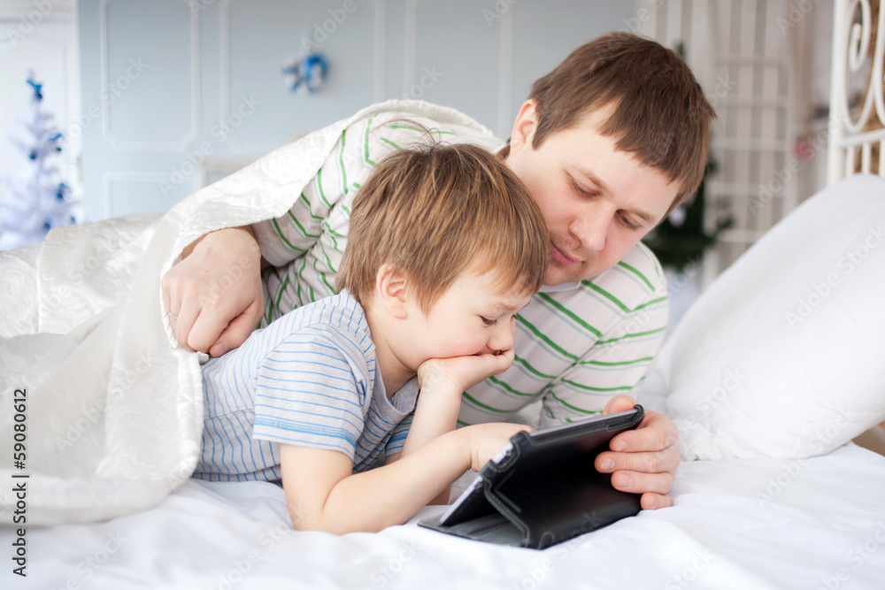Father and son playing on tablet Father and son playing on tablet