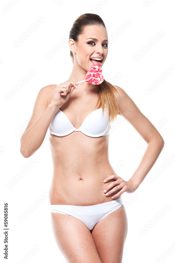 Fototapeta premium Young sexy girl licking lollypop