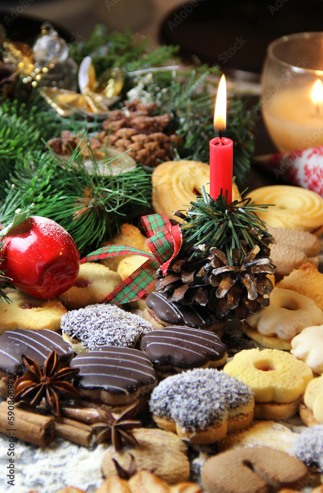 Mix of Christmas cookies with cinnamon and candle Mix of Christmas cookies with cinnamon and candle