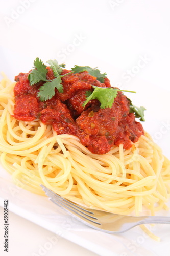 Pasta with meatballs decorated with coriander
