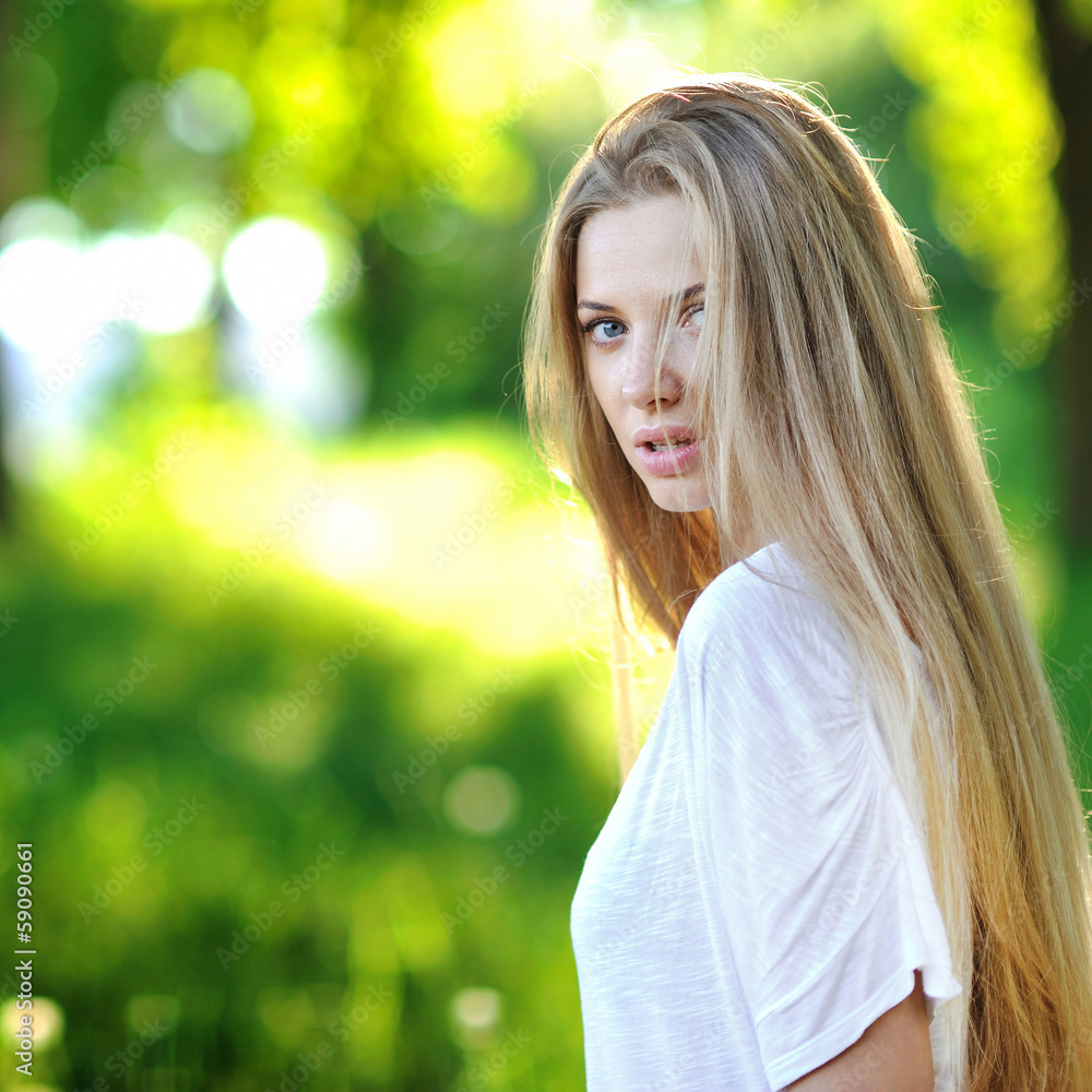 Young beautiful woman portrait in summer park Young beautiful woman portrait in summer park