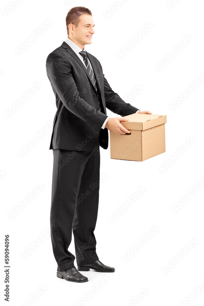 Smiling businessman in suit giving a box to someone Smiling businessman in suit giving a box to someone