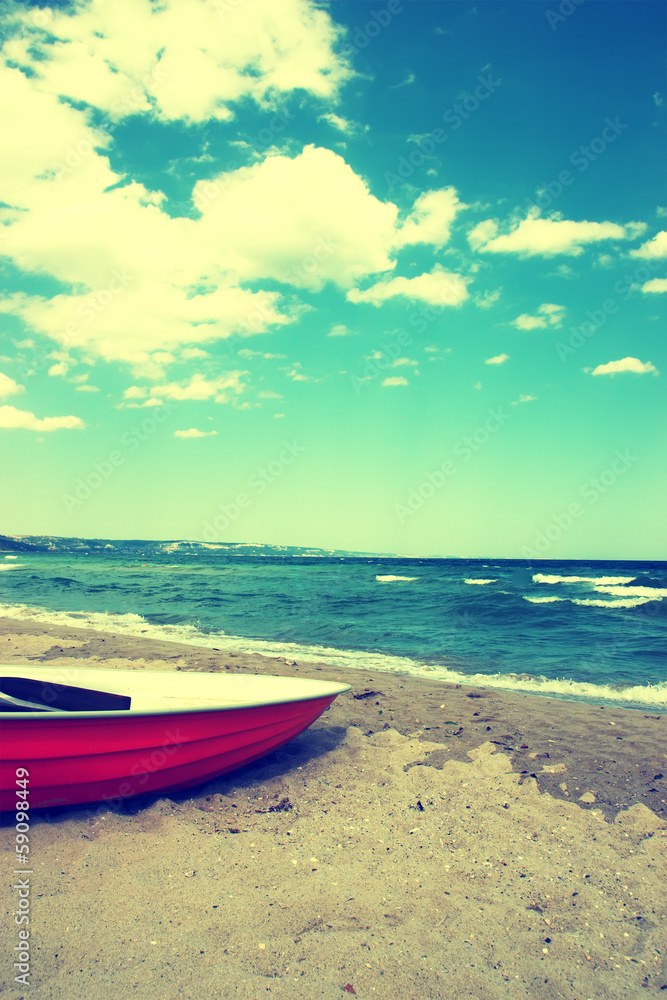 Naklejka premium Boat on the beach.Vintage Beach Background