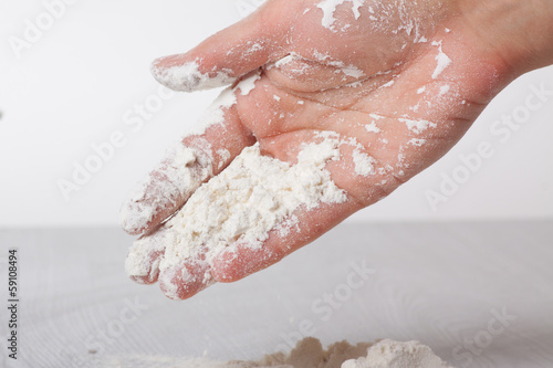 Hands and white wheat flour