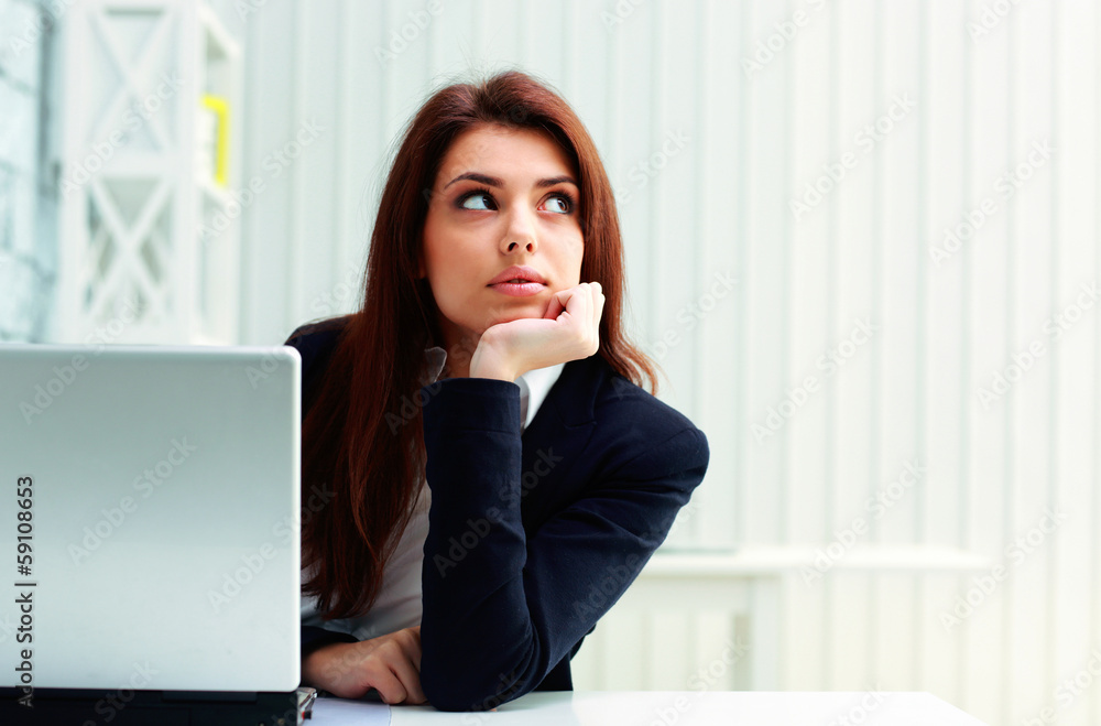 Young happy businesswoman sitting at the table Young happy businesswoman sitting at the table
