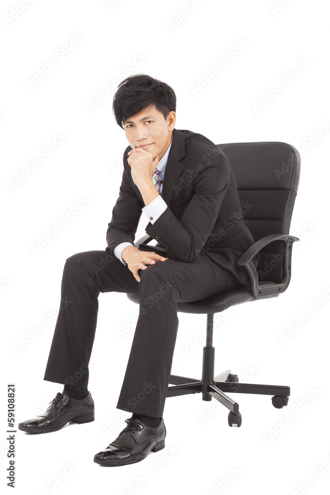 Young businessman thinking and sitting in a chair Young businessman thinking and sitting in a chair