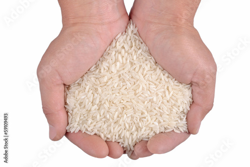 Uncooked white rice in the hands on a white