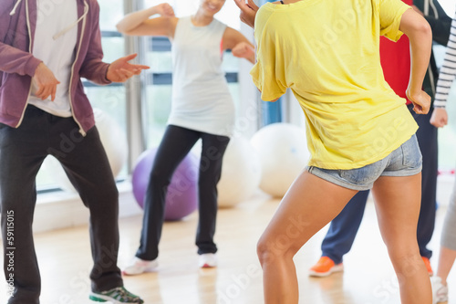 Low section of fitness class and instructor doing pilates exerci