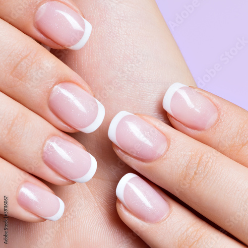 woman's nails with beautiful french white manicure photo