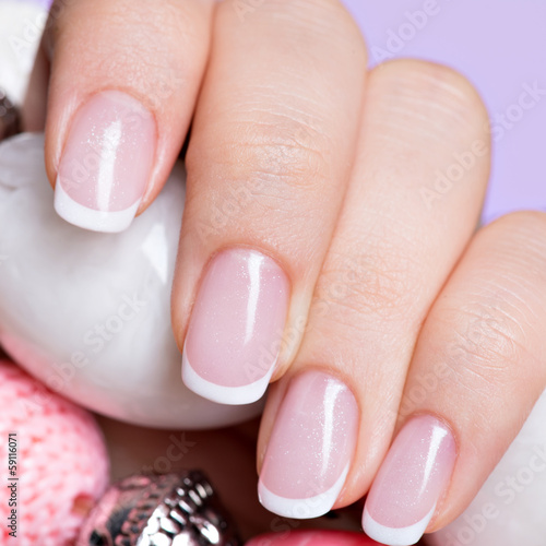woman's nails with beautiful french white manicure