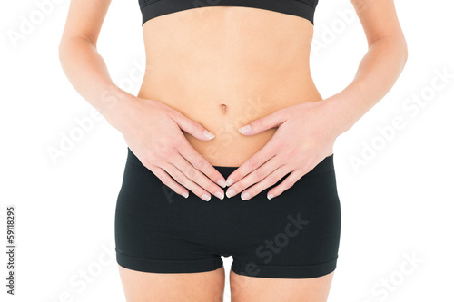Close-up mid section of a fit woman with stomach pain © lightwavemedia