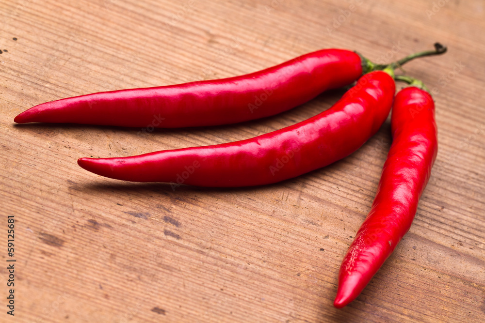 Red Hot Chili Peppers over wooden background 