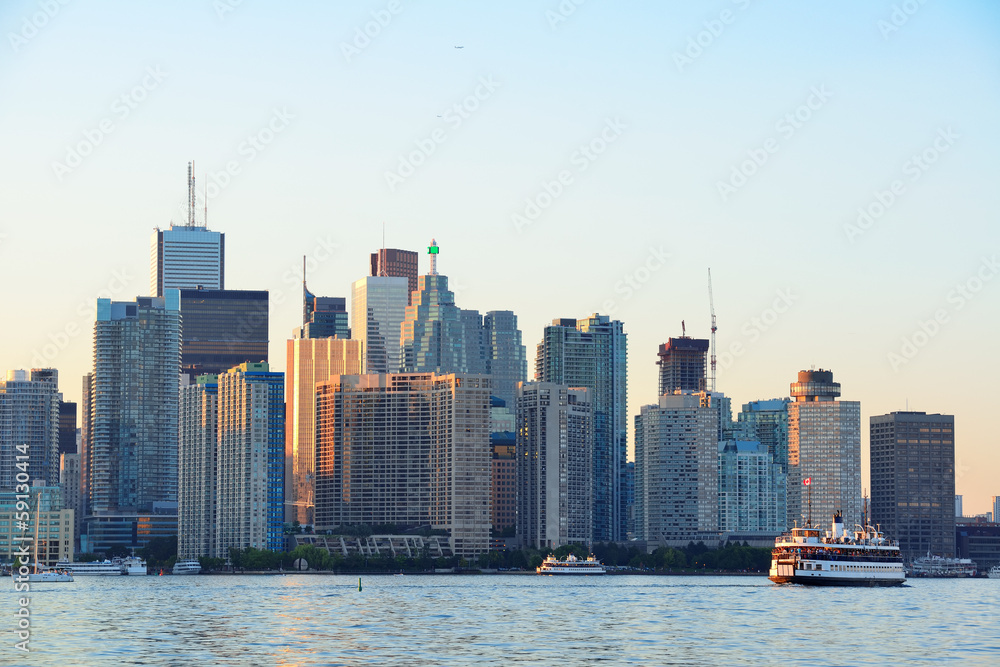 Naklejka premium Toronto skyline with boat, urban architecture and blue sky