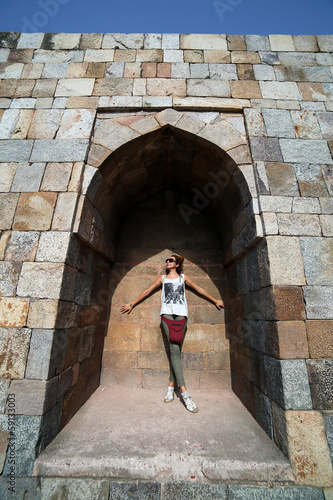 Caucasian tourist girl at Qutb Minar  New Delhi