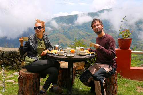 Tourist couple eating breakfast at himalayas mountains