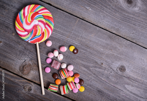 lollipop and candy on wooden background