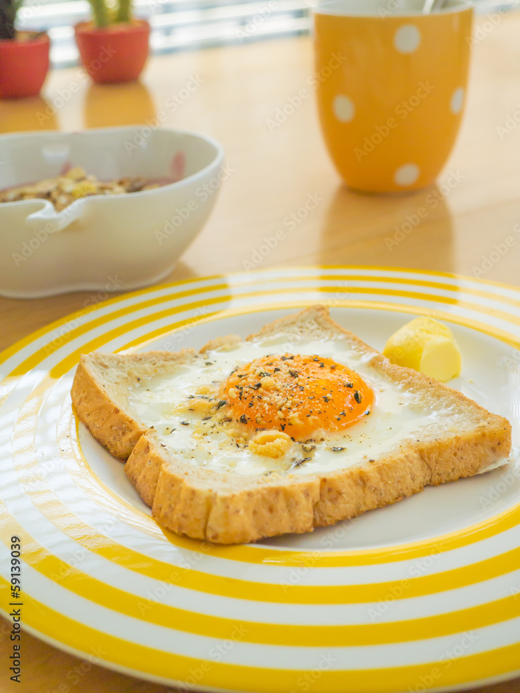 Breakfast . Fried egg on the toast , Muesli yogurt and coffee. Breakfast . Fried egg on the toast , Muesli yogurt and coffee.