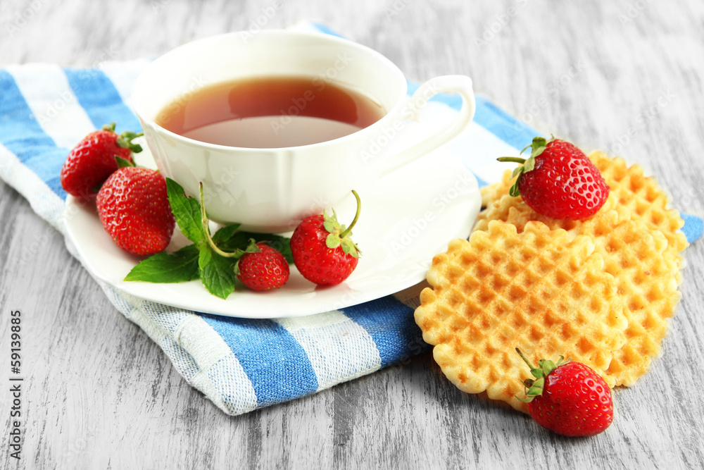 Cup of tea with cookies and strawberries on table close-up Cup of tea with cookies and strawberries on table close-up