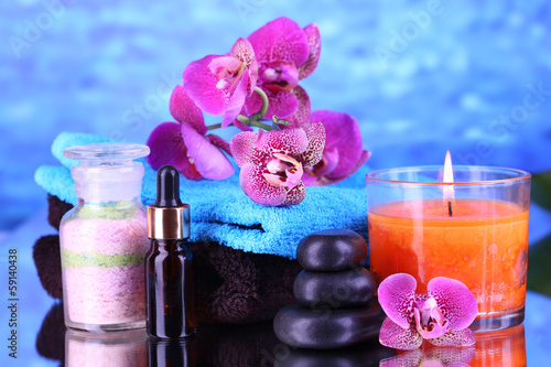 Beautiful spa setting with orchid on blue background