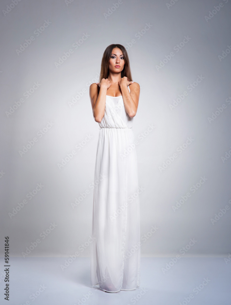 A young and beautiful woman in a white greek dress