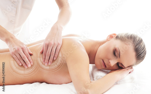 Back of a young woman on a massage procedure