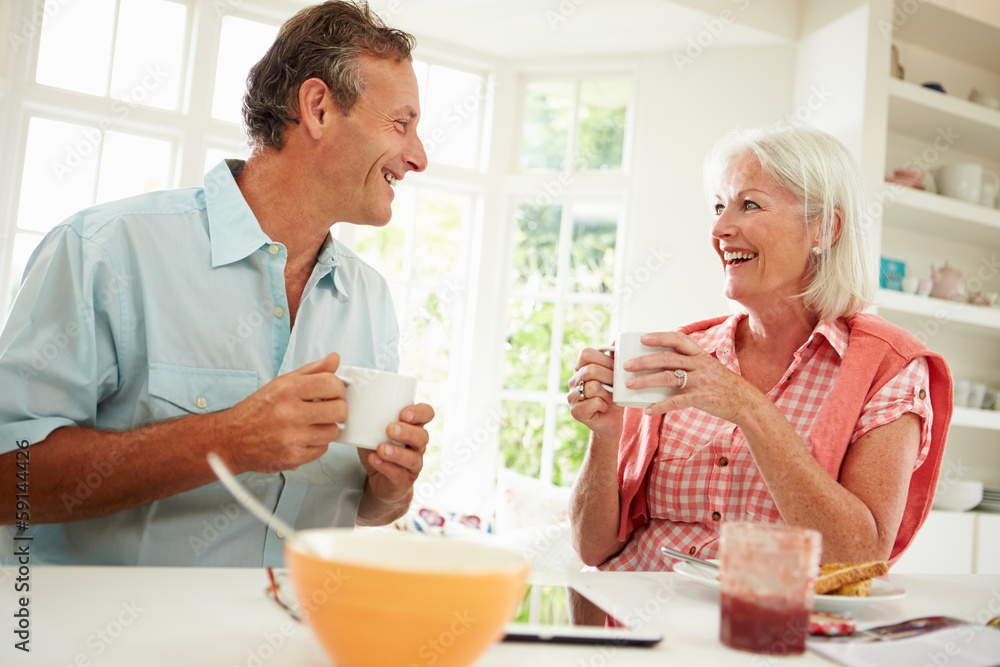 Middle Aged Couple Enjoying Breakfast At Home Together Middle Aged Couple Enjoying Breakfast At Home Together