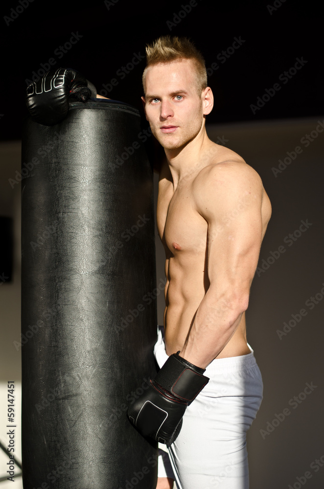Handsome young boxer shirtless with boxing gloves