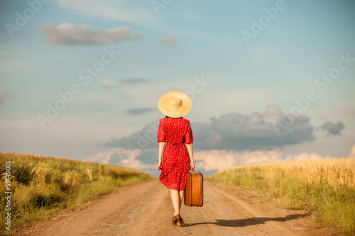 Canvas Print Redhead girl with suitcase at outdoor.