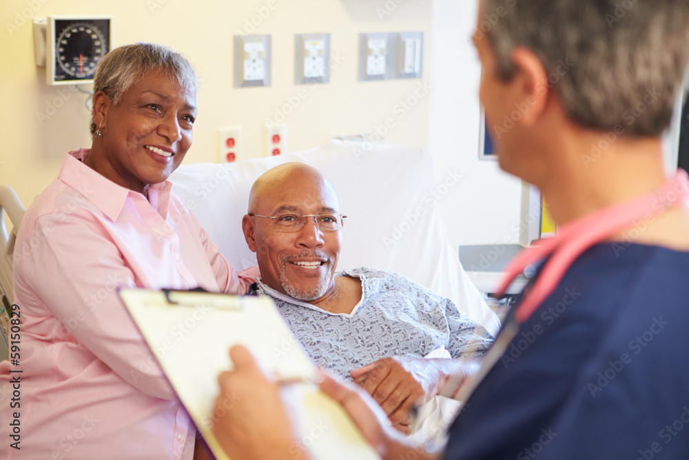 Close Up Of Male Nurse Updating Patient Notes Close Up Of Male Nurse Updating Patient Notes