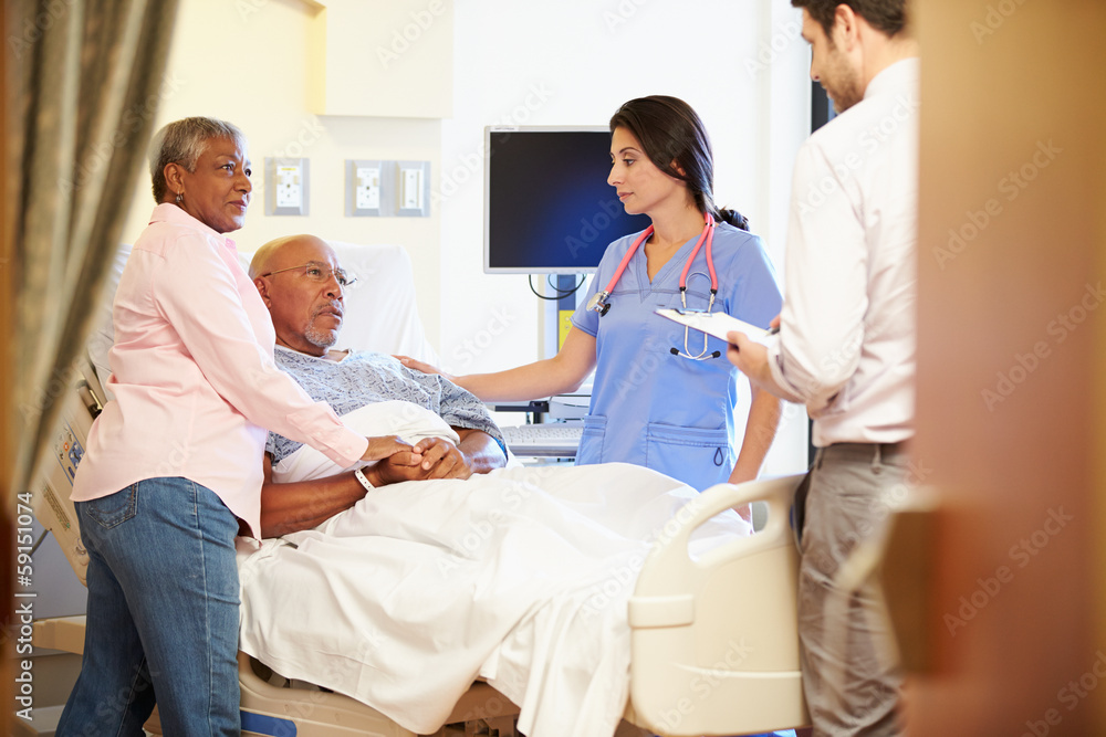 Fototapeta premium Medical Team Meeting With Senior Couple In Hospital Room