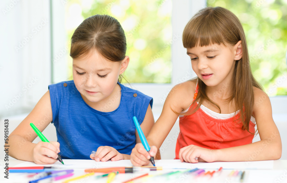 Little girls are drawing using felt- tip pens Little girls are drawing using felt- tip pens