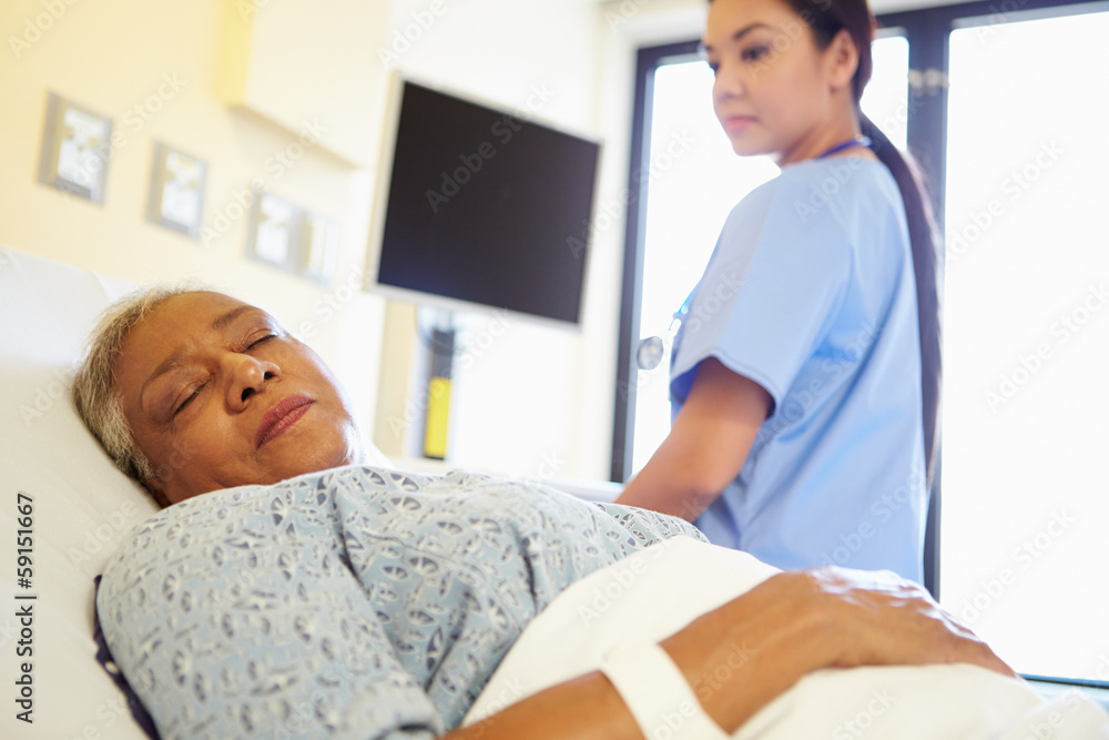 Obraz premium Nurse Watching Sleeping Senior Woman Patient In Hospital