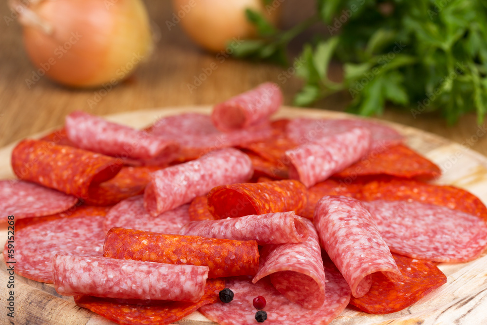 slices of salami with parsley and onions slices of salami with parsley and onions
