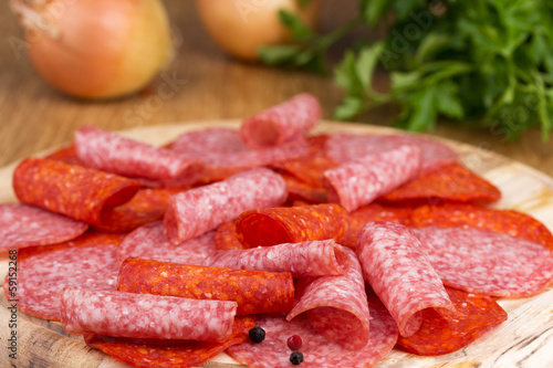 slices of salami with parsley and onions