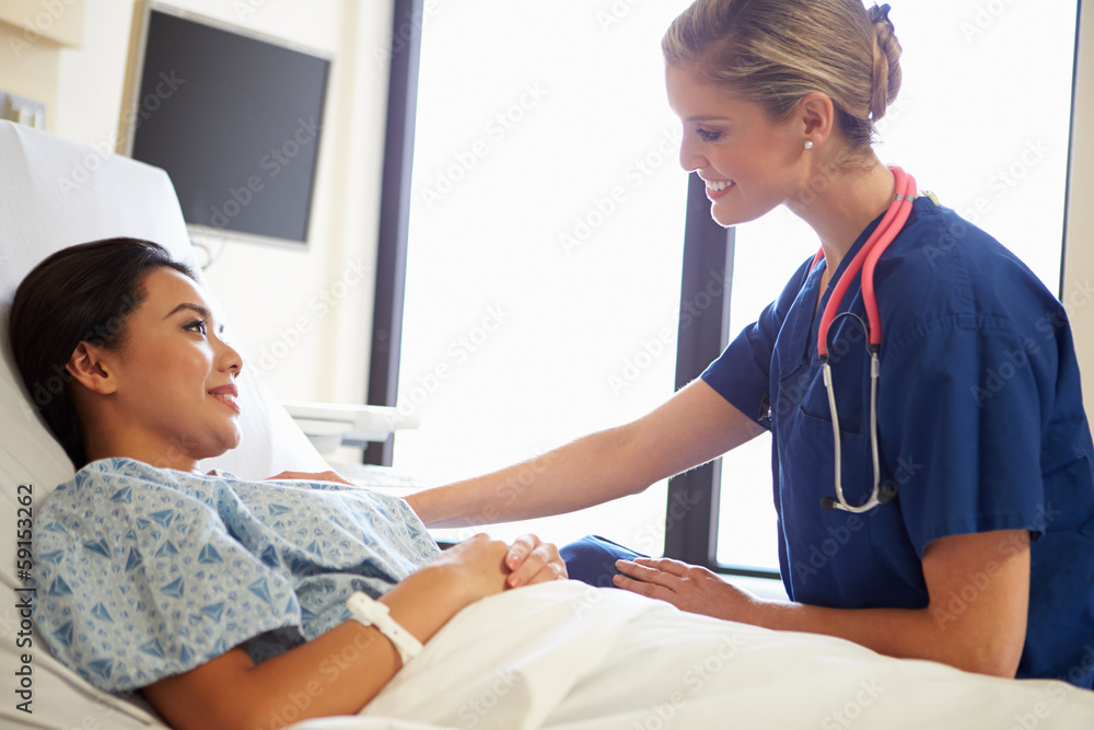Nurse Talking To Female Patient On Ward Nurse Talking To Female Patient On Ward