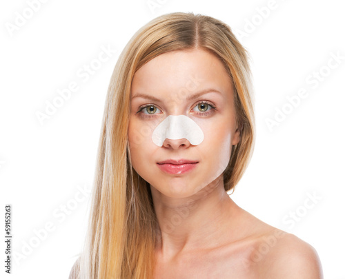 Portrait of teenage girl with clear-up strips on nose photo