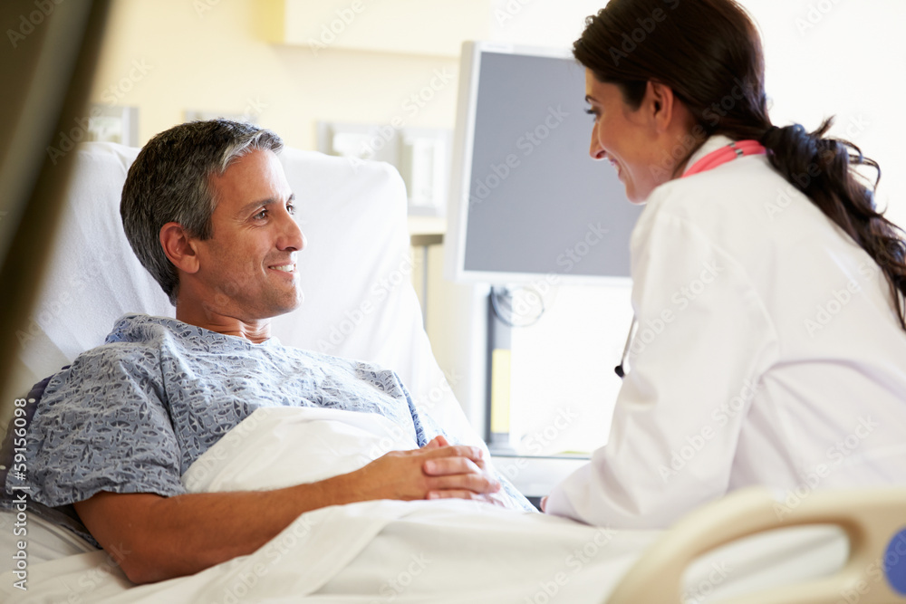 Female Doctor Talking To Male Patient In Hospital Room Female Doctor Talking To Male Patient In Hospital Room