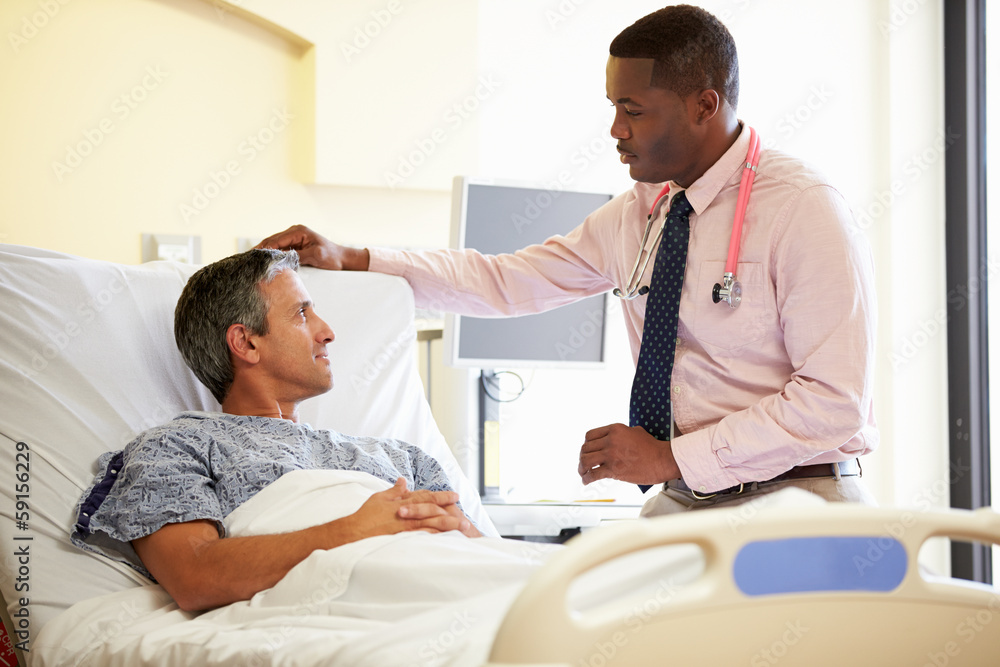 Doctor Talking To Male Patient In Hospital Room Doctor Talking To Male Patient In Hospital Room