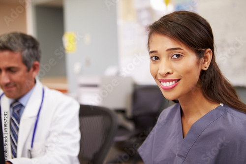 Portrait Of Female Nurse Working At Nurses Station